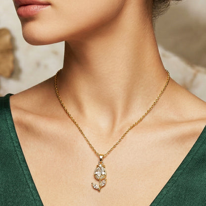 Woman wearing gold tulip pendant necklace with crystal stones elegant minimal jewelry styling