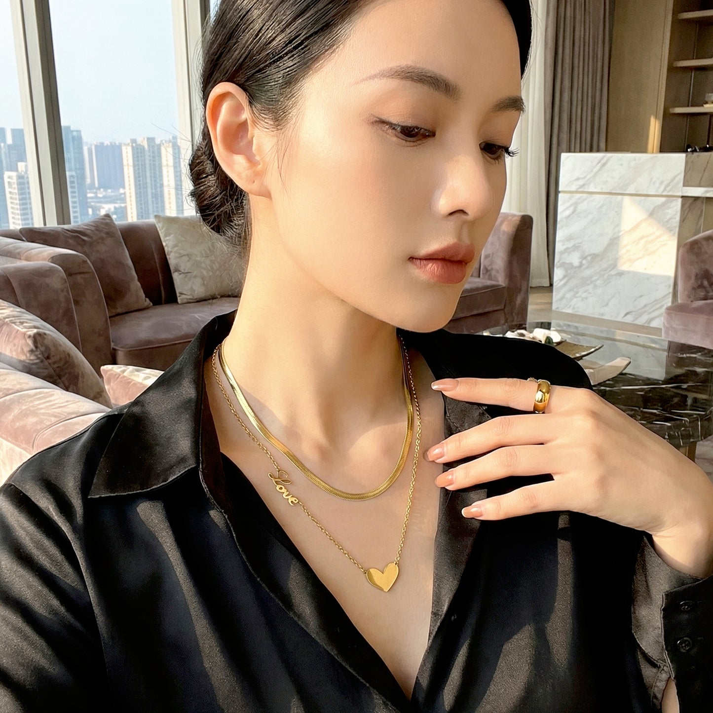 model wearing layered gold necklace elegant office style
