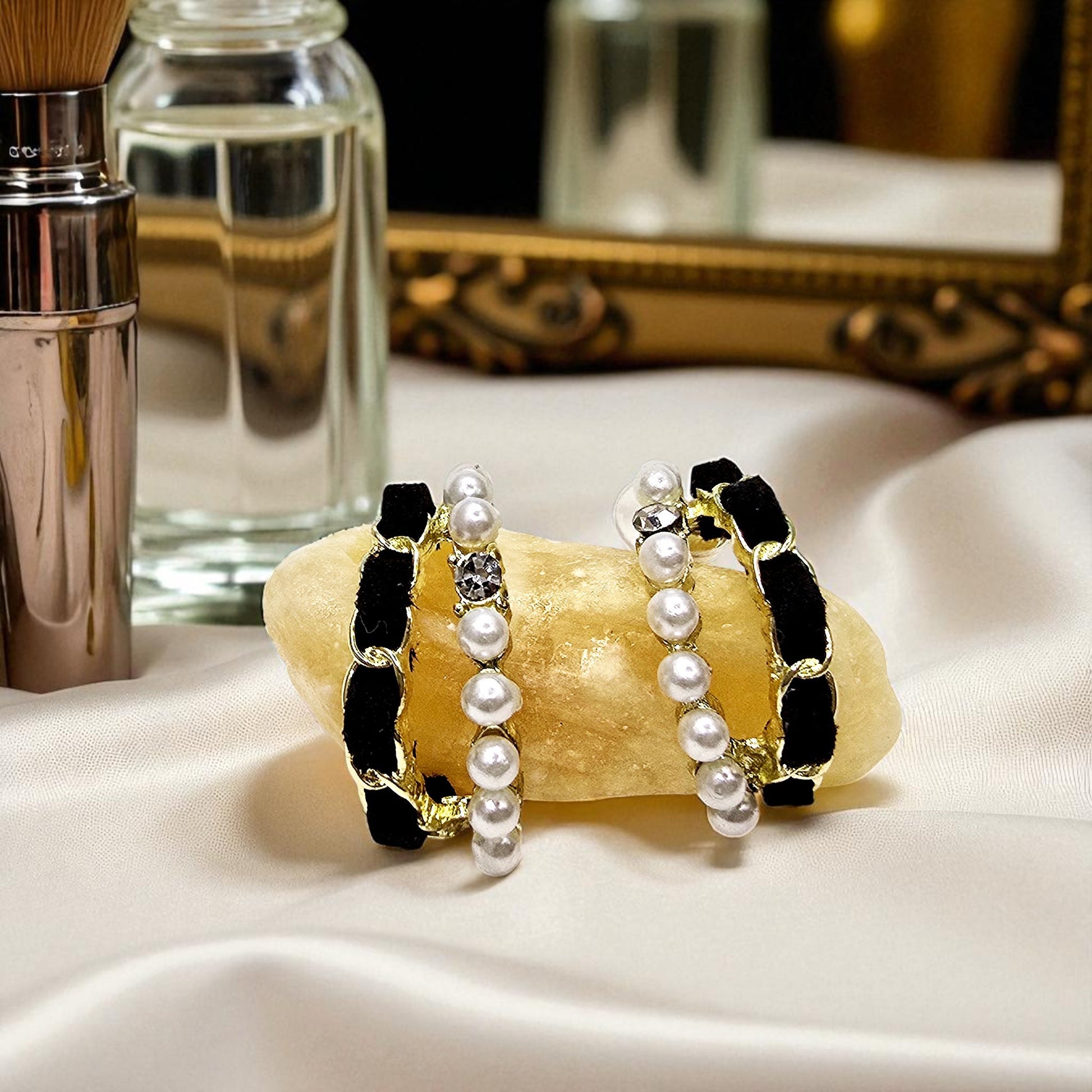 Velvet Pearl Earrings styled on satin fabric with reflective background