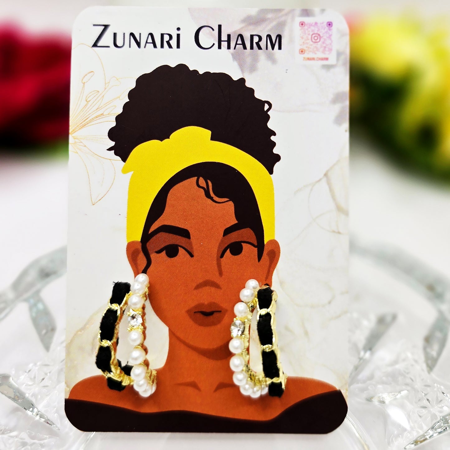 Earrings displayed on Zunari Charm branded jewelry card