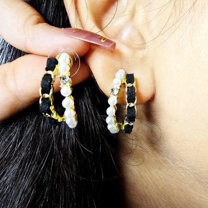Close-up of model wearing Velvet Pearl Earrings—black velvet hoops with pearls and crystal accents