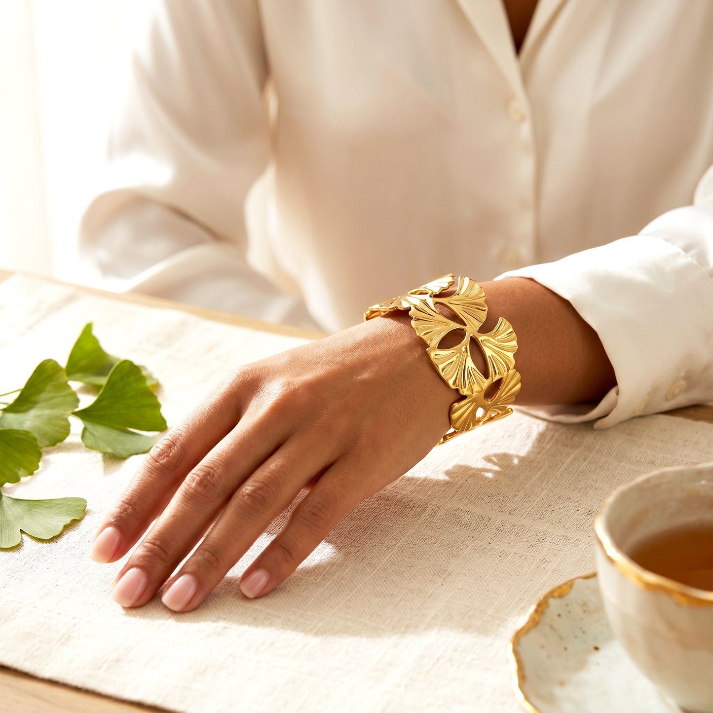 Woman wearing Venus gold cuff bracelet elegant styling