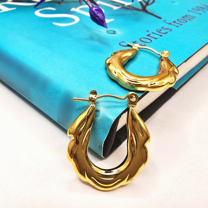 Zigzag Hoop Earrings – chic gold hoops placed on a blue book