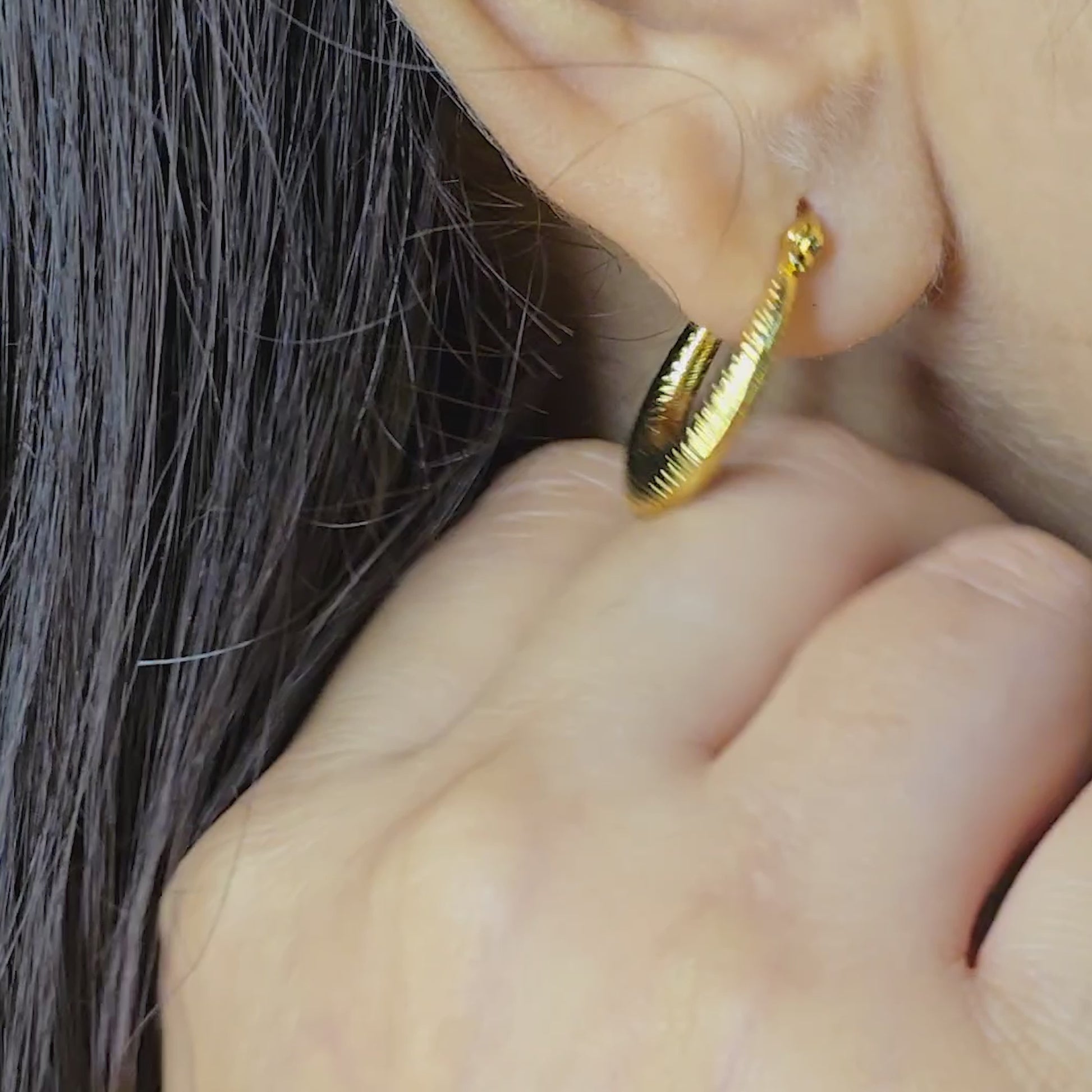 Model wearing vintage crescent gold textured hoop earrings close-up, showcasing their bold anti-tarnish design.
