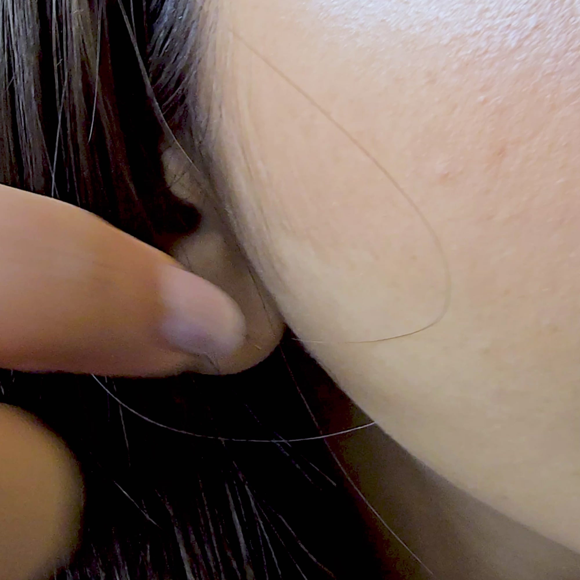 A detailed view of the model wearing only the Etched Heart studs from the 3-in-1 set. The camera focuses on the intricate, wavy etched pattern on the heart's surface, demonstrating its use as a sophisticated, everyday minimalist accessory.