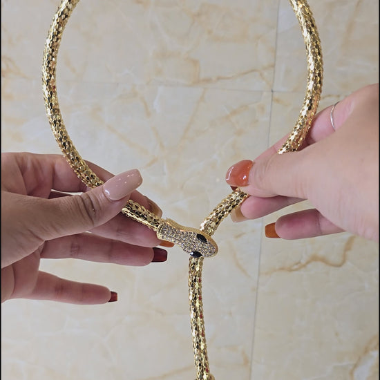 360-degree view of Serpent Embrace Necklace – gold snake choker with sparkling crystal detailing, showcasing magnetic closure feature for secure fit.