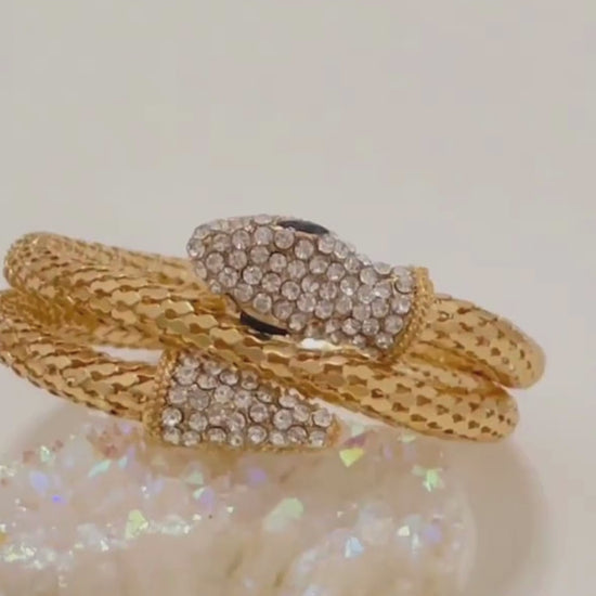 video of the Serpent Bracelet in gold finish, featuring detailed close-ups of the snakehead design, scale texture, and adjustable open-end. Showcased under natural and soft studio lighting to highlight its bold, anti-tarnish finish and statement appeal.