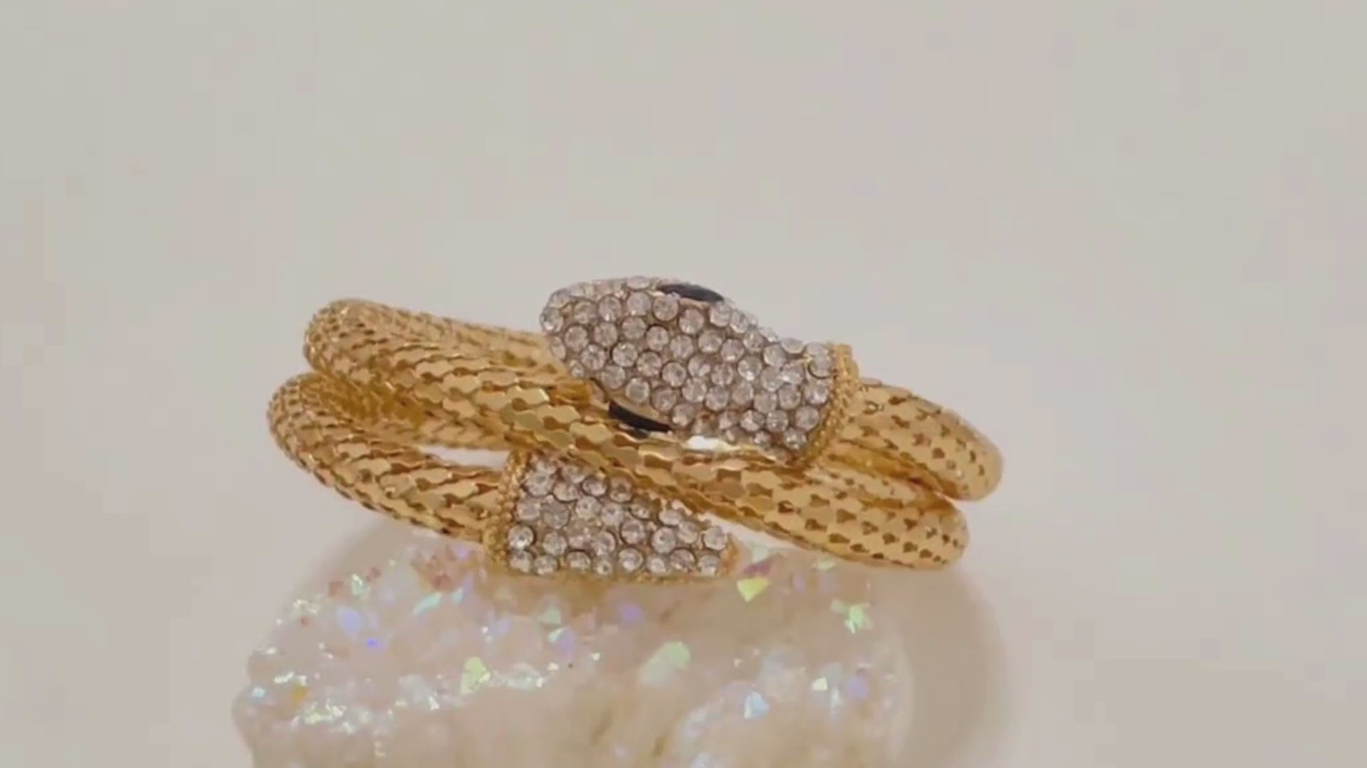 video of the Serpent Bracelet in gold finish, featuring detailed close-ups of the snakehead design, scale texture, and adjustable open-end. Showcased under natural and soft studio lighting to highlight its bold, anti-tarnish finish and statement appeal.