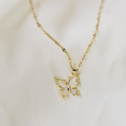 360-degree video of Crystal Butterfly Pendant Chain on white background, showing gold-toned necklace with sparkling crystal butterfly pendant and enamel detailing.
