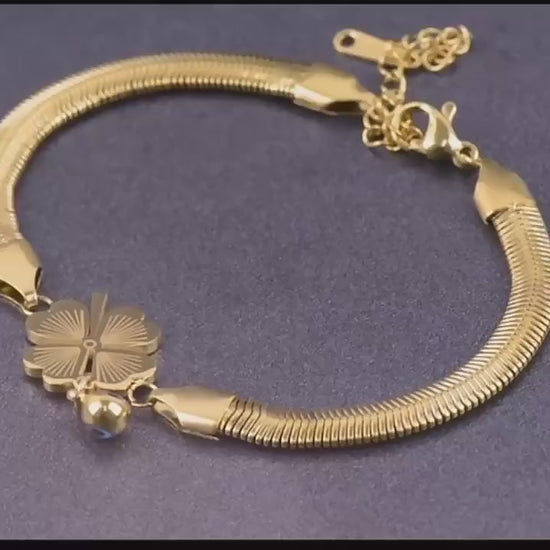 Video showcasing the Clover Charm Snake Chain Bracelet with 360° rotation and close-up views. Features glossy gold snake chain and delicate white clover charms, highlighting its minimalist, waterproof, and anti-tarnish finish.