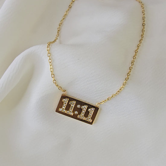 360° video of gold-plated 11:11 Pendant Chain showcasing its rectangular crystal-studded pendant, reflective shine, and lightweight chain, symbolizing manifestation and synchronicity.