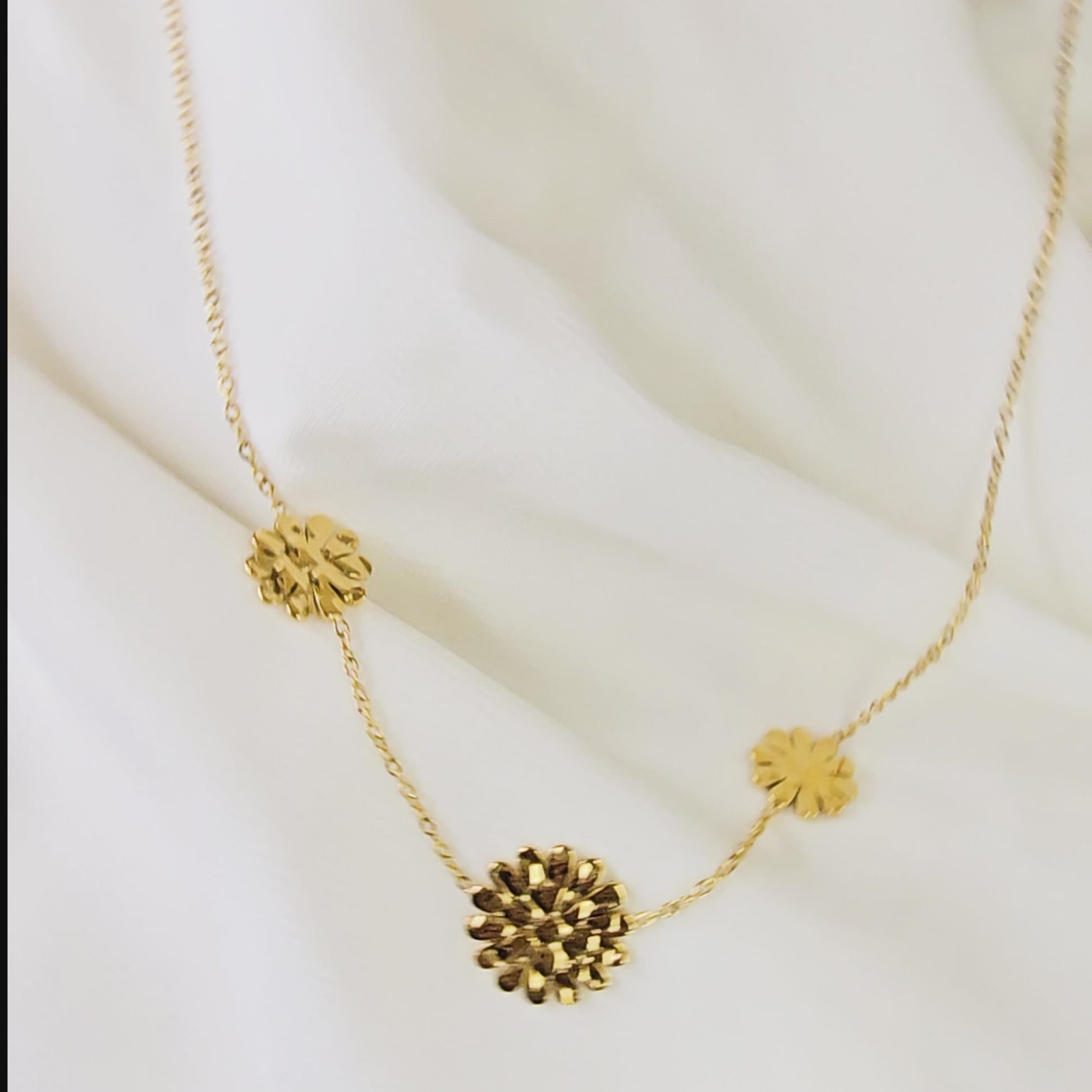 Video showing the detail and movement of the gold marigold flower charms and dainty chain.