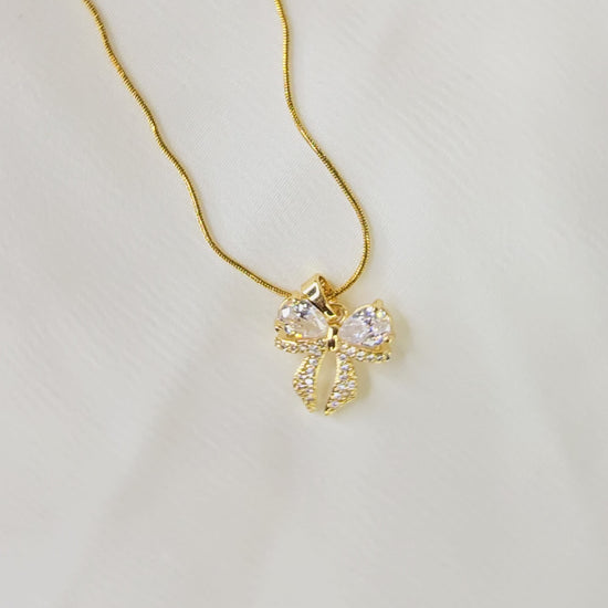 360-degree video of AD Bow Necklace showing pendant details and sparkle under light.