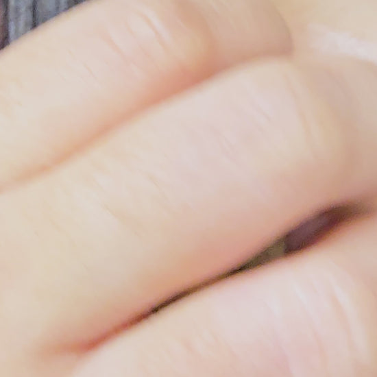 Video demonstration showing the light-reflecting hammered finish and secure fit of the gold V sculptural earrings on a model.