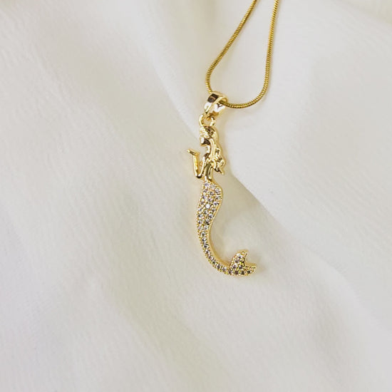 Video showing the sparkle and detail of the pavé crystal mermaid pendant and gold snake chain.