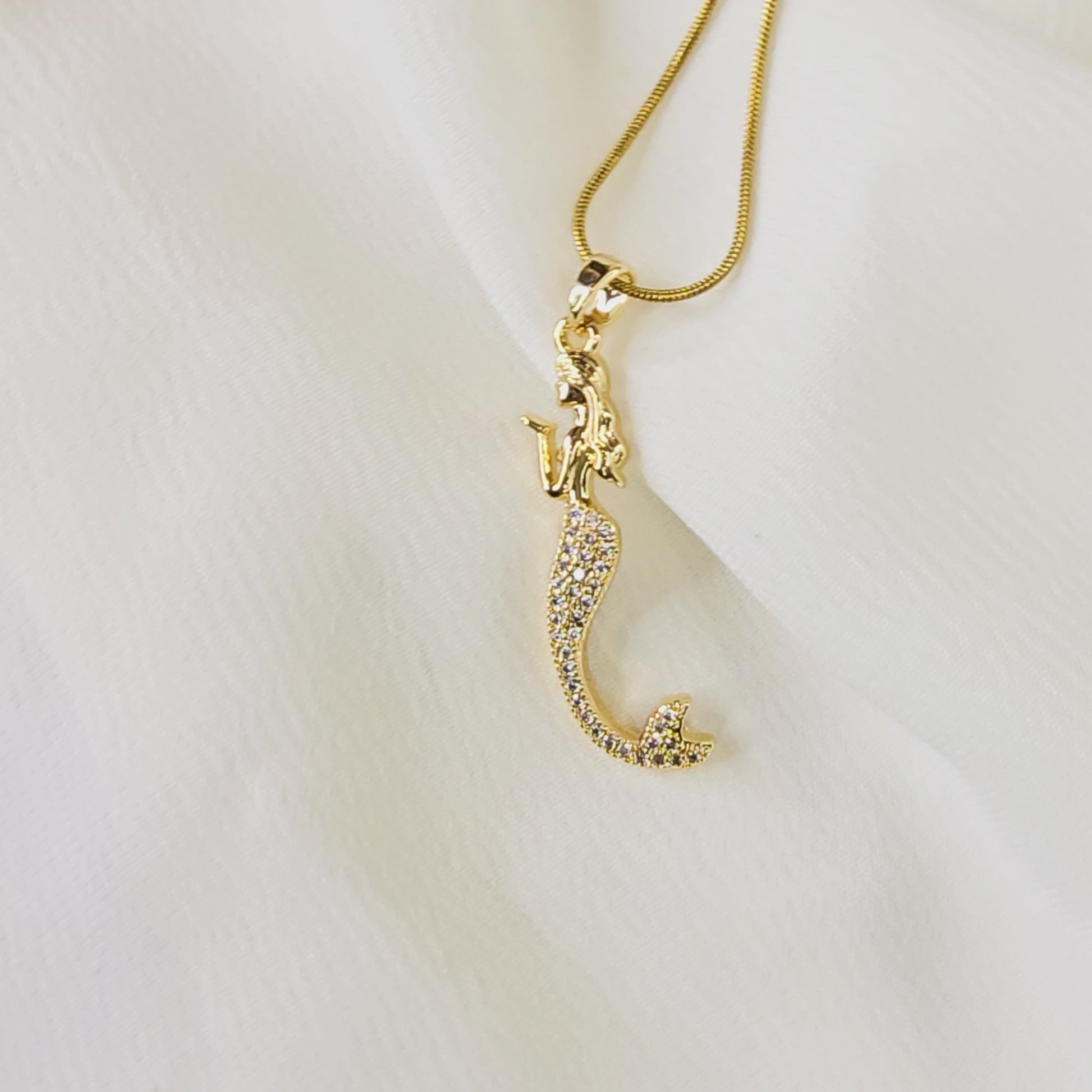 Video showing the sparkle and detail of the pavé crystal mermaid pendant and gold snake chain.