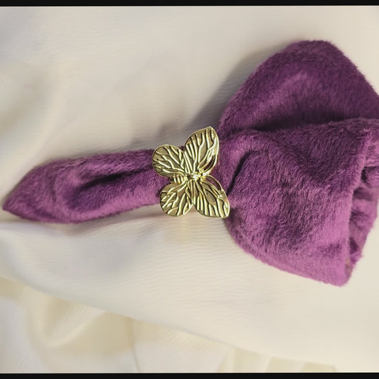 360-degree product video of a gold butterfly statement ring from Zunari Charm, rotating on a display table. The video highlights intricate wing details and a polished finish, showcasing the ring’s elegant design and shine.