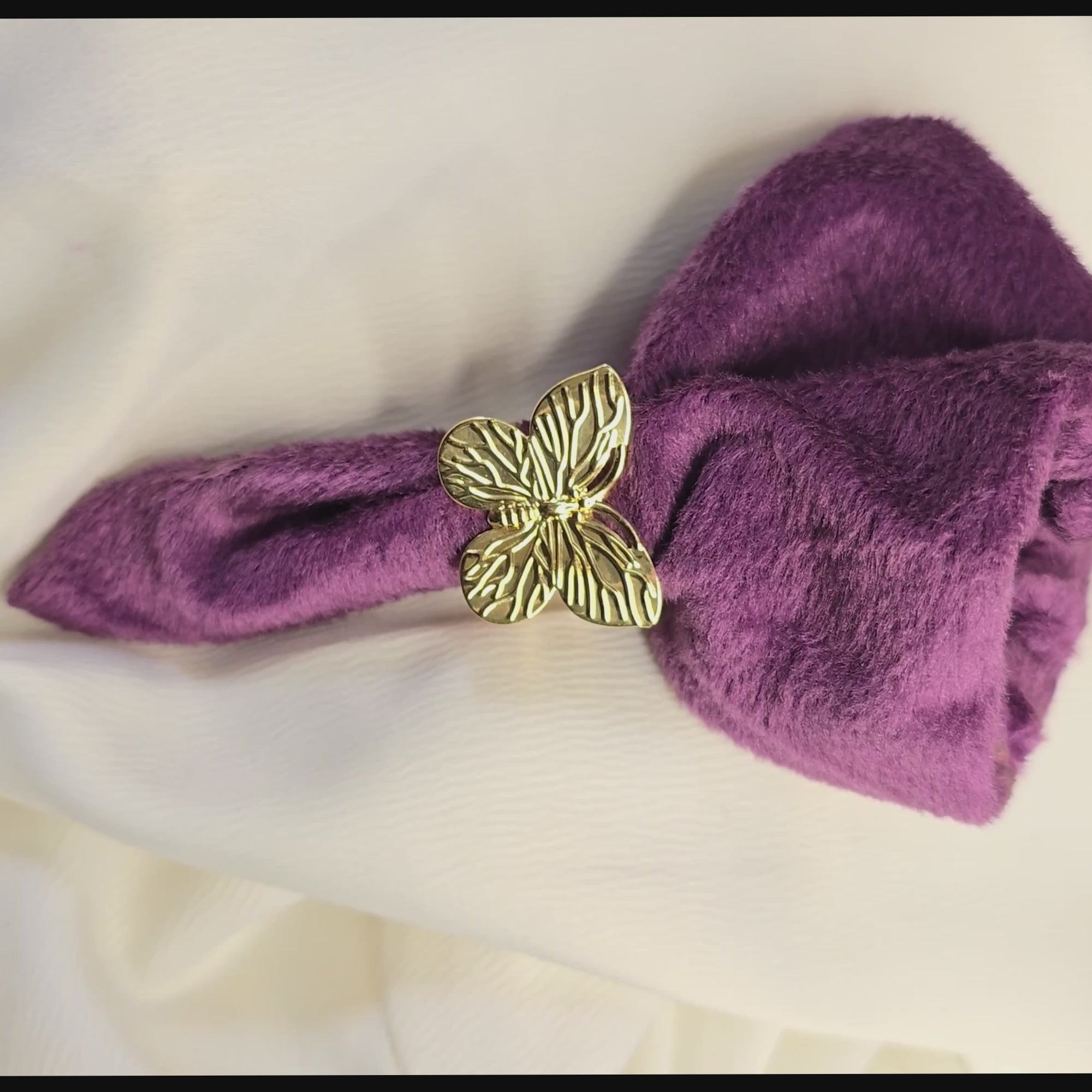 360-degree product video of a gold butterfly statement ring from Zunari Charm, rotating on a display table. The video highlights intricate wing details and a polished finish, showcasing the ring’s elegant design and shine.