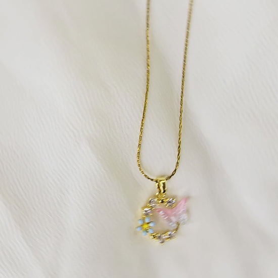 Video showcasing the delicate detail and movement of the gold butterfly and forget-me-not pendant.