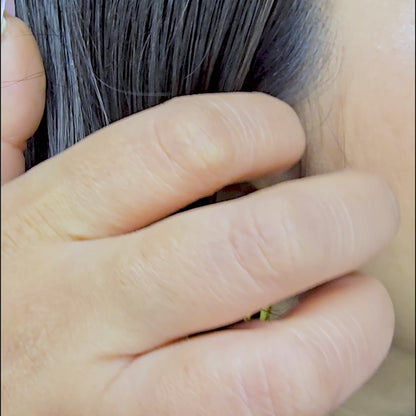 Video demonstration showing the brilliant 18k gold shine and secure fit of the molten teardrop studs on a model.