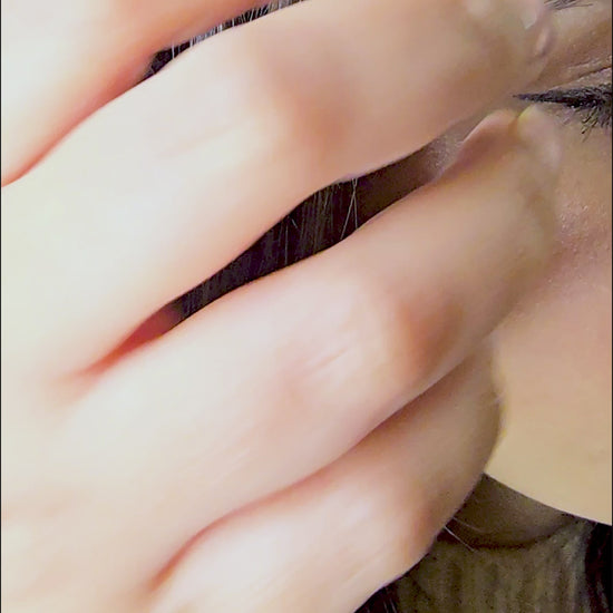 Video demonstration showing the fluid movement and light-reflecting gold of the Vertex sculptural earrings on a model.