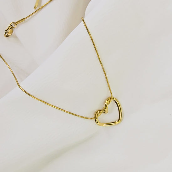 Video showing the smooth, three-dimensional curvature of the gold-plated twisted heart pendant.